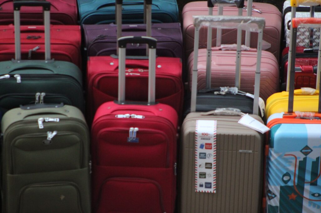 a vibrant collection of various suitcases stacked in preparation for travel.