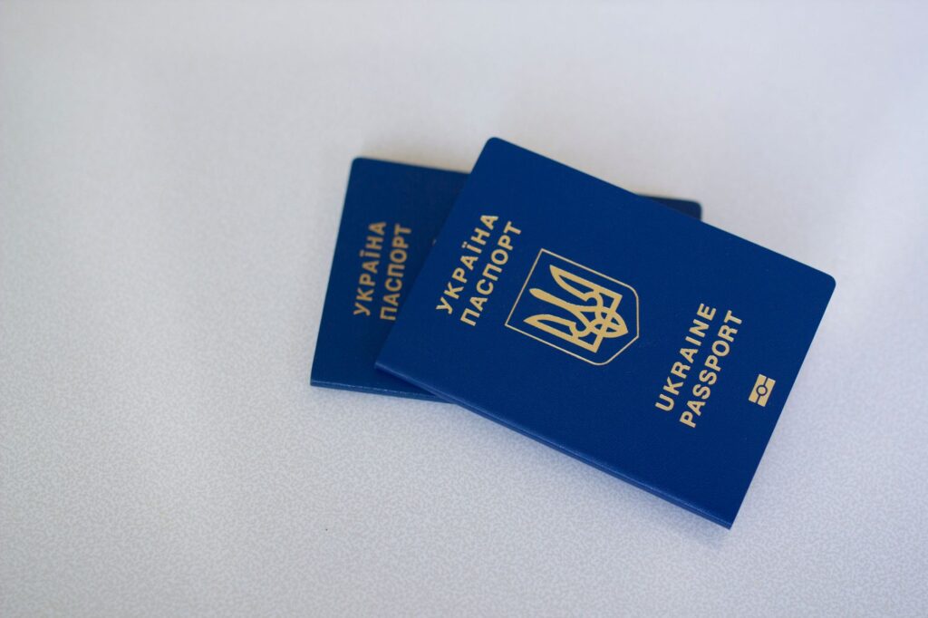 image of two ukrainian passports on a white surface, highlighting travel and identification themes.