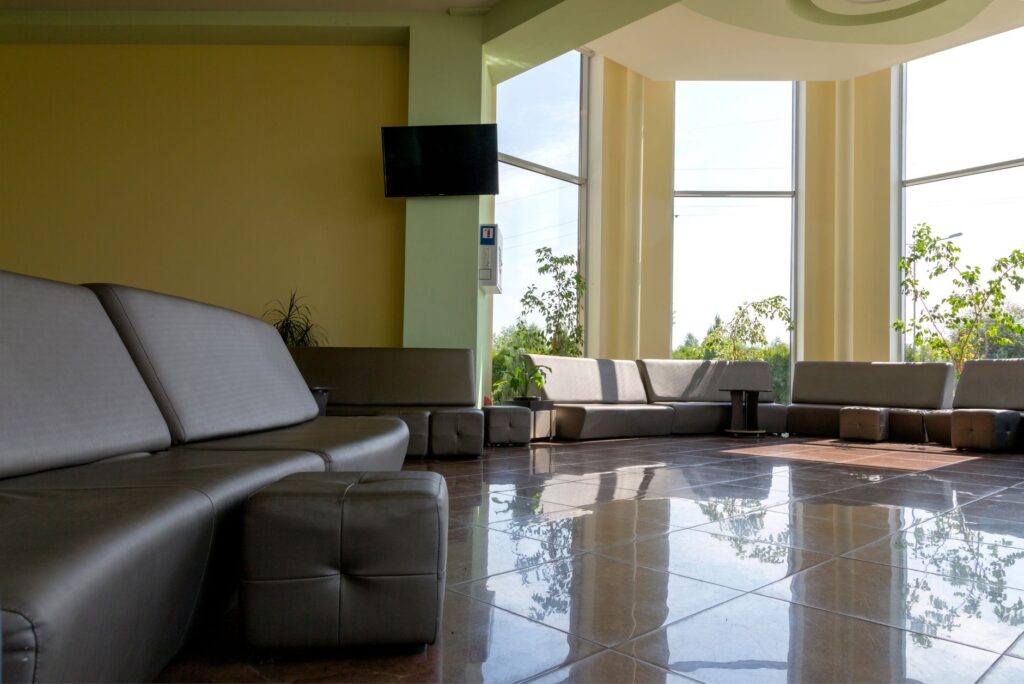 spacious lobby with sleek furniture and large windows letting in bright daylight.