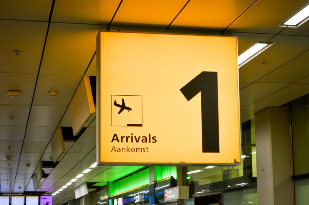 bright arrivals sign with airplane symbol in an airport terminal.